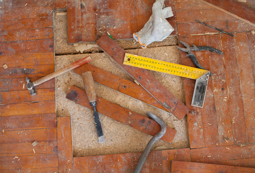 Nolan Painting Company- Havertown, PA measuring a missing piece of the hardwood floor